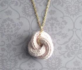 Etarnally. Crochet knot pendant in baby pink.