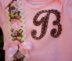 Baby girl boysuit accented with initial and beautiful ribbon. Newborn to toddler sizes.