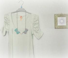 Opposites attract. Crochet bow necklace. Mint green and grey.