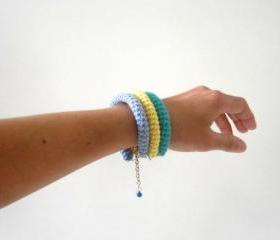 Orbits, crochet bracelet in emerald green, yellow and blue.