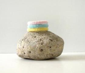 Orbits, crochet bracelet in mint green, yellow and pink.