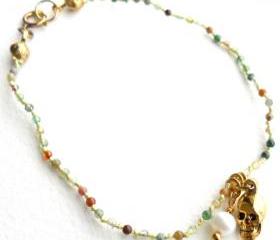 Charm Bracelet Multicolor Agate hand-knotted in silk with gold skull and freshwater cultured white pearl charms.