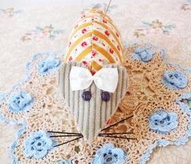 vintage style mouse pin cushion with mustard fabric and floral pins