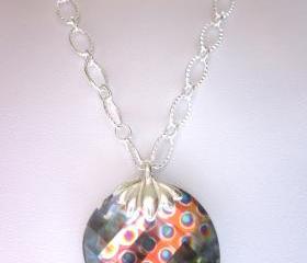 Necklace, Sparkling Swarovski Crystal Peacock Eye faceted Twist pendant on a silver chain.