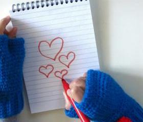 Oliver Twist,wrist high crochet fingerless mittens with removable pom-pom brooch in blue.