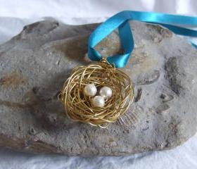 Brass Nest Pendant: A cute birds nest pendant made from wire with three white pearl bead eggs.