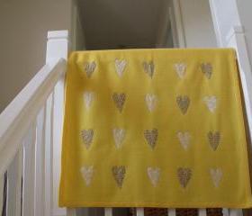 yellow baby blanket with sewn on hearts