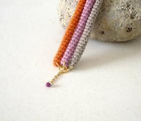 Orbits, crochet bracelet in lavender, orange and sand
