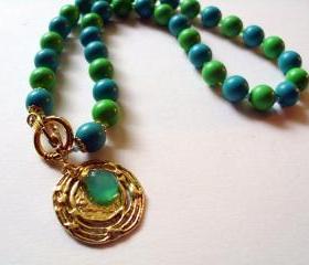 Gold disc lariat necklace with blue and green vintage beads