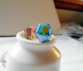 blue faceted hexagon ring with copper wire wraps