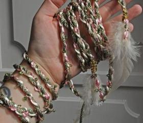 Handfasting cord in sage green and dusky pink, featuring delicate rose braid and feather embellishments
