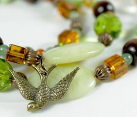 green earth tone beaded necklace with bird charm