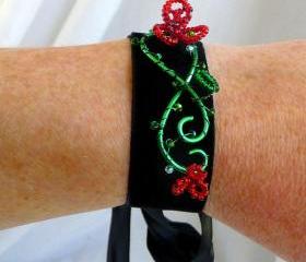 Velvet cuff with red beaded flowers