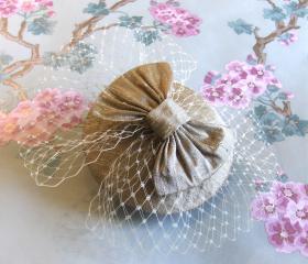 Gold and champagne silk cocktail hat.