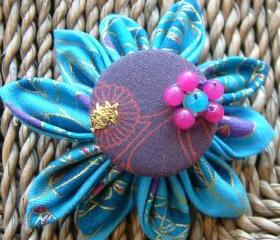 Tsumami Kanzashi flower brooch with a twist