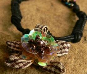 Macramed cotton necklace with plaid flower pendant and shell accents