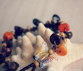 gemstone bracelet with a glass butterfly