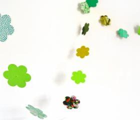 Green garland in cardboard flowers