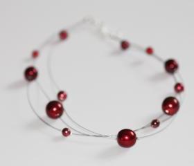 Floating multi strand illusion necklace in red glass pearls