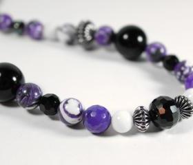 long beaded necklace in purple black and white