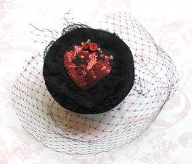 Ruby red heart cocktail hat.