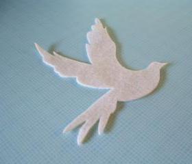 Flying dove on white felt