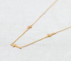 Three tiny Sideways Cross Necklace in gold