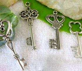 Four silver key charms