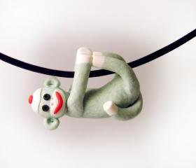 Green Sock Monkey Pendant Swinging from all fours handmade in Polymer Clay